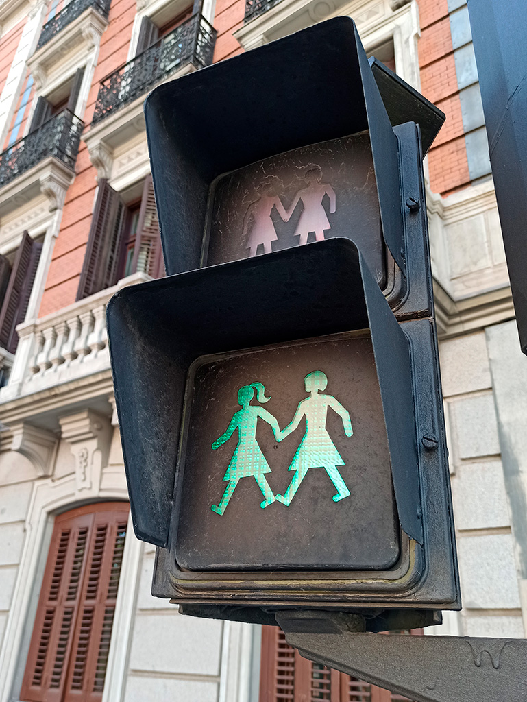 Madryt, sygnalizator uliczny, zielone światło: dwie trzymające się za ręce dziewczyny